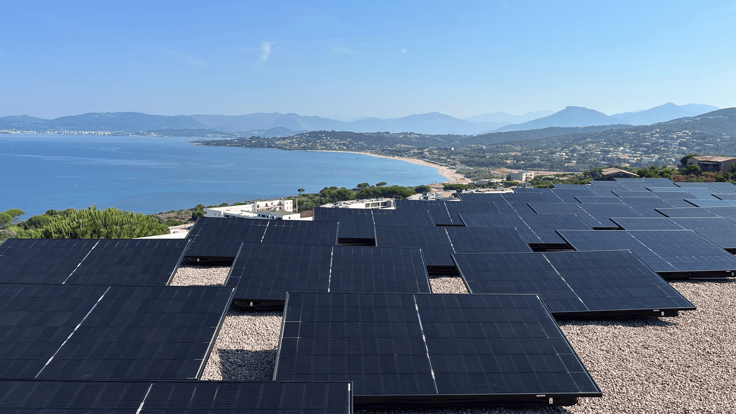 Solar panels installed on a modern villa overlooking the Corsican coastline